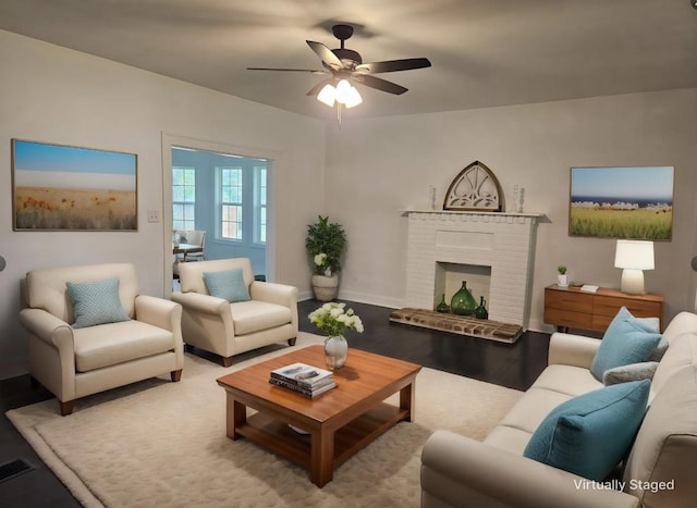 living room featuring ceiling fan, a fireplace, and light hardwood / wood-style floors