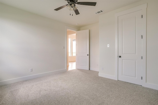 unfurnished bedroom with ceiling fan and carpet