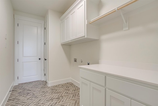 clothes washing area with washer hookup, cabinets, and electric dryer hookup