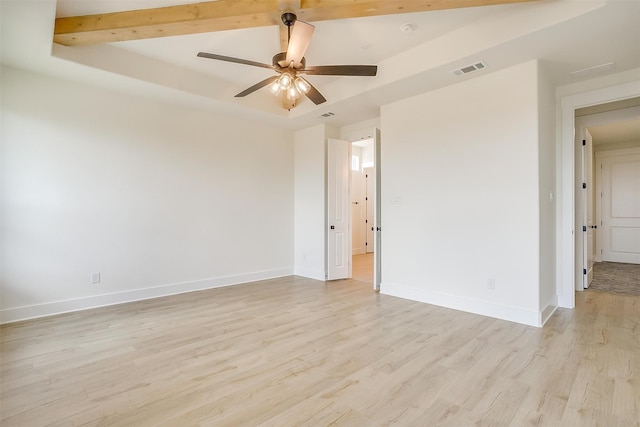 unfurnished room featuring light wood-type flooring, a raised ceiling, and ceiling fan