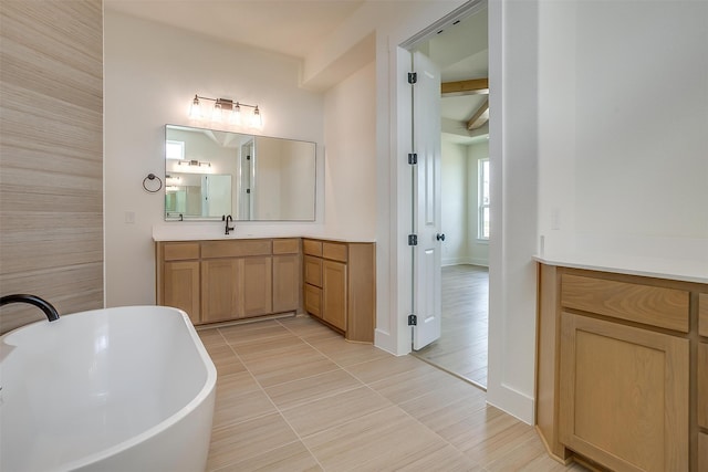 bathroom with vanity, tile walls, tile patterned floors, and a washtub