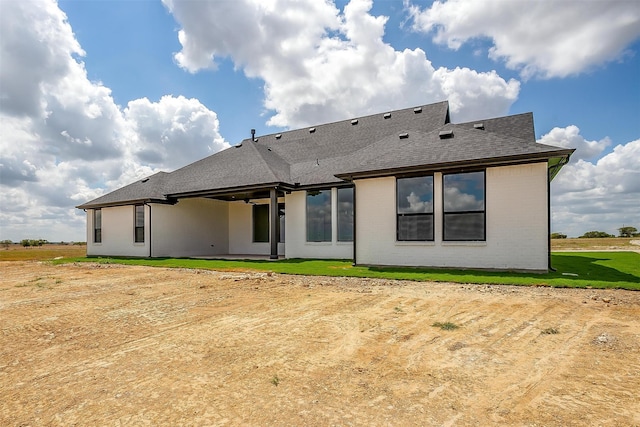 rear view of house with a yard