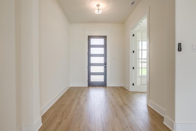 entryway featuring a wealth of natural light and light hardwood / wood-style flooring