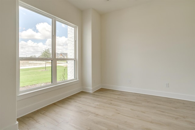 empty room with light hardwood / wood-style flooring