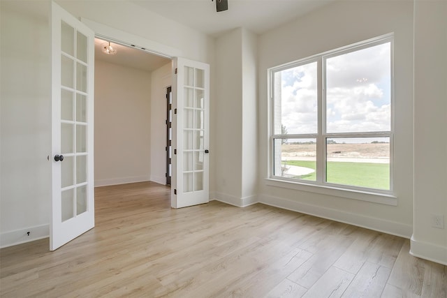 empty room featuring light hardwood / wood-style flooring and french doors