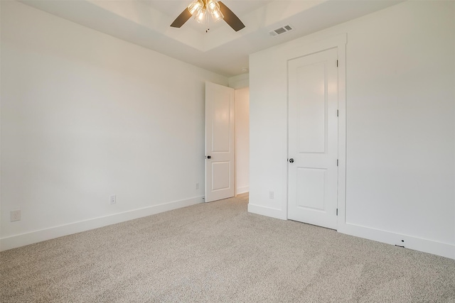 unfurnished bedroom featuring ceiling fan and light carpet