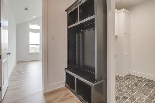 mudroom with lofted ceiling and hardwood / wood-style floors