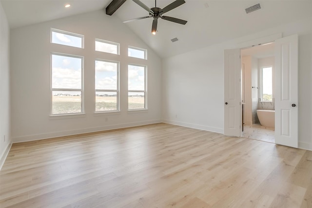 empty room featuring light wood-type flooring, a healthy amount of sunlight, beam ceiling, and ceiling fan