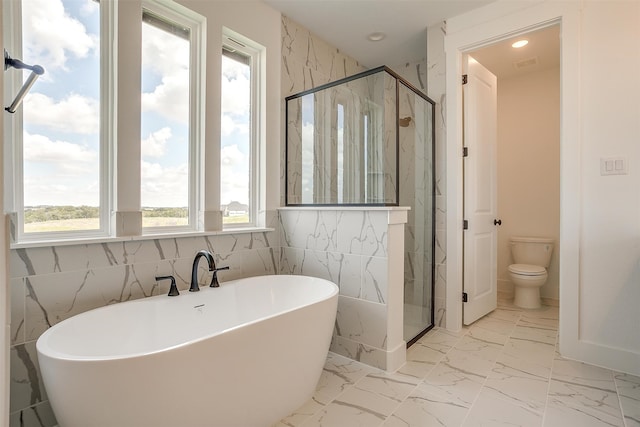 bathroom featuring shower with separate bathtub, toilet, and tile walls