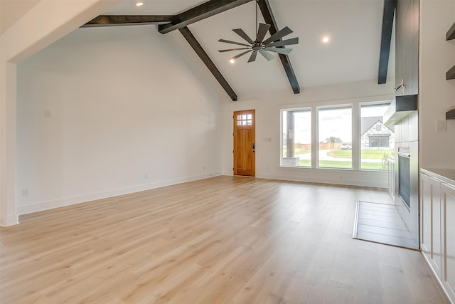 unfurnished living room with high vaulted ceiling, beam ceiling, ceiling fan, and light hardwood / wood-style floors