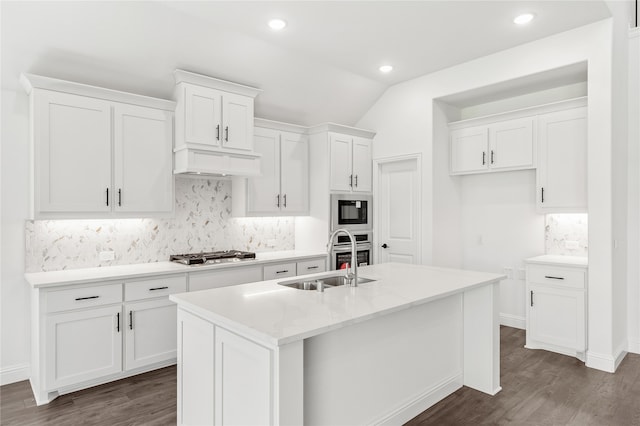 kitchen with white cabinetry, stainless steel gas cooktop, an island with sink, and dark hardwood / wood-style floors