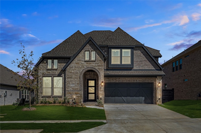 view of front facade with a front yard and a garage