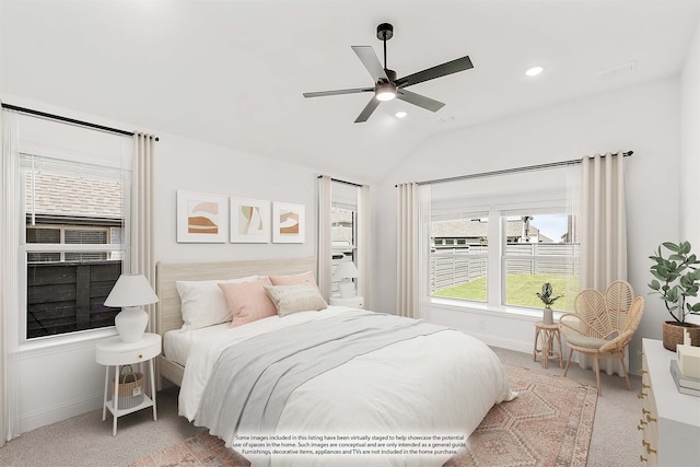 carpeted bedroom featuring lofted ceiling and ceiling fan