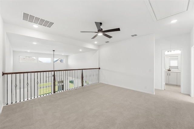 carpeted empty room featuring ceiling fan