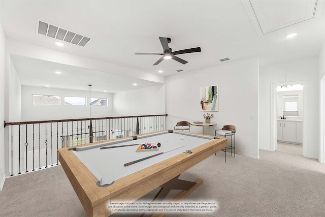 game room with a wealth of natural light, light colored carpet, and ceiling fan