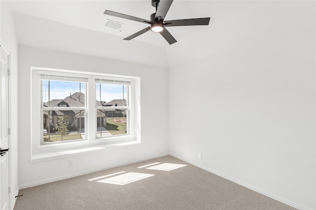 spare room with ceiling fan and carpet