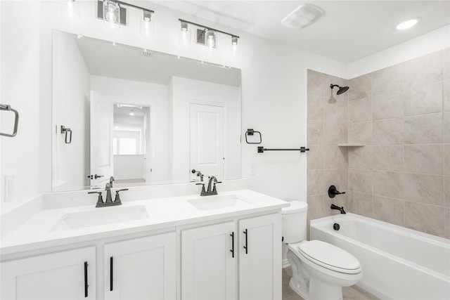 full bathroom with toilet, tiled shower / bath combo, and vanity