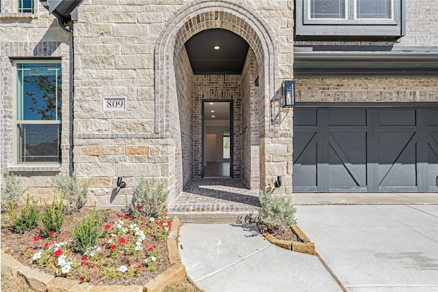 view of exterior entry featuring a garage