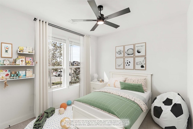 carpeted bedroom with multiple windows and ceiling fan