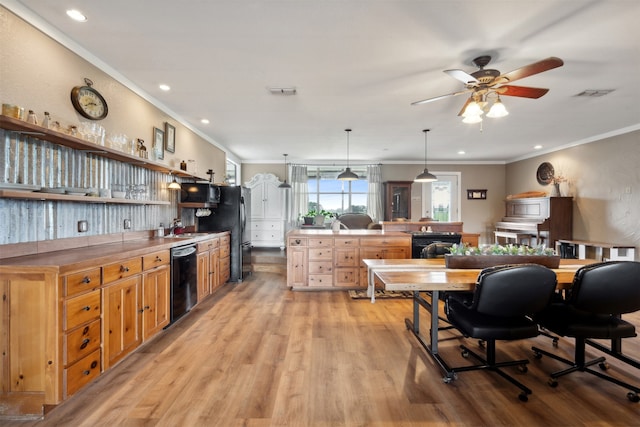 kitchen with light wood-type flooring, ceiling fan, crown molding, black appliances, and hanging light fixtures