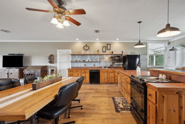 kitchen with wood counters, tasteful backsplash, light hardwood / wood-style floors, decorative light fixtures, and black appliances