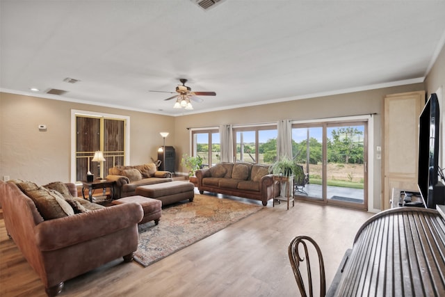 living room with ceiling fan, light hardwood / wood-style floors, and ornamental molding