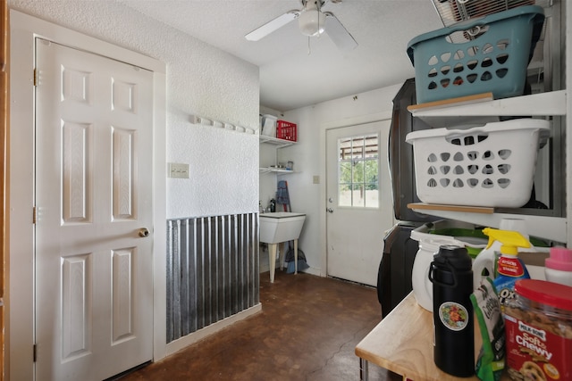 laundry area featuring stacked washer and dryer and ceiling fan