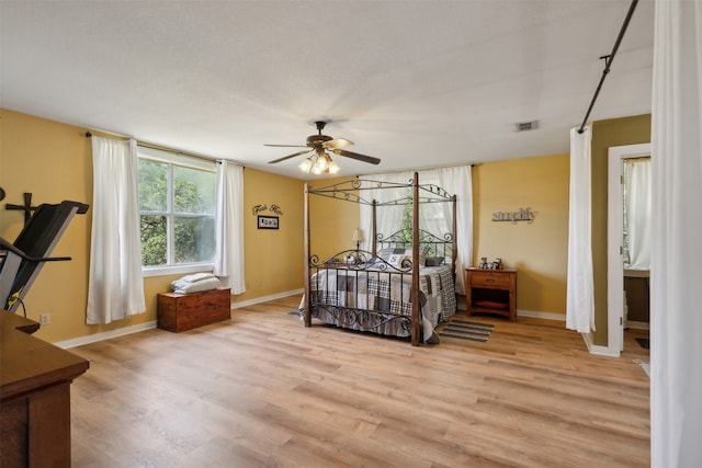 bedroom with ceiling fan and light hardwood / wood-style floors