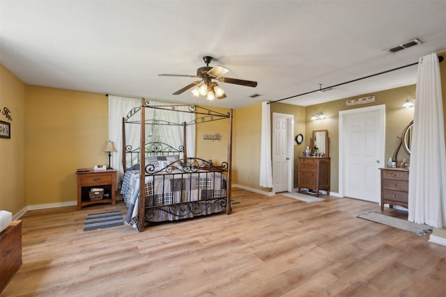 bedroom with ceiling fan and light hardwood / wood-style floors