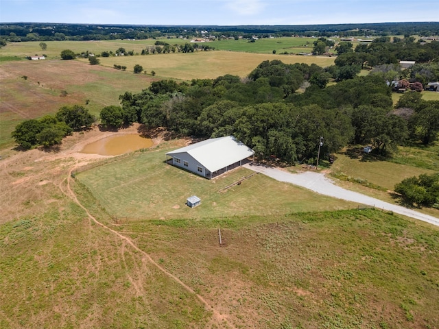 birds eye view of property with a rural view