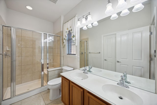 bathroom featuring tile patterned floors, vanity, toilet, and walk in shower