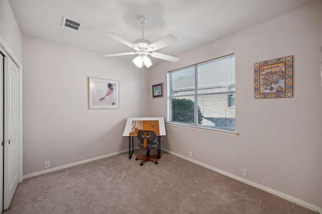 misc room featuring light colored carpet and ceiling fan