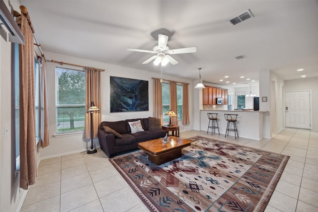 living room with ceiling fan, a healthy amount of sunlight, and light tile patterned flooring