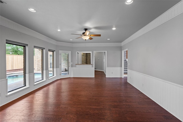 unfurnished living room featuring ceiling fan, dark hardwood / wood-style flooring, and ornamental molding