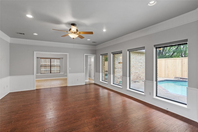 unfurnished room with hardwood / wood-style flooring, crown molding, and ceiling fan