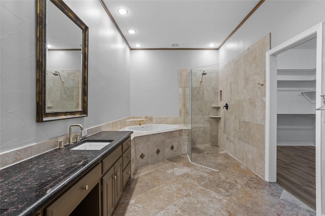 bathroom featuring separate shower and tub, vanity, and ornamental molding