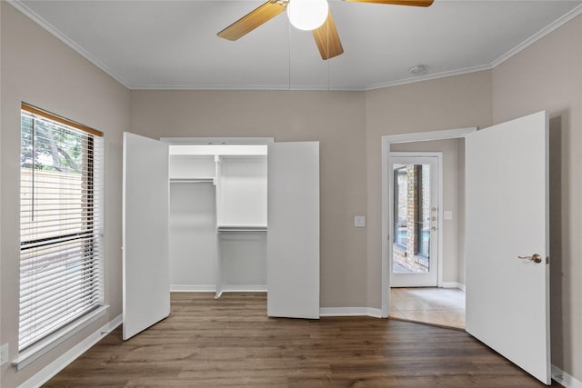 unfurnished bedroom featuring ornamental molding, a closet, ceiling fan, and dark hardwood / wood-style flooring