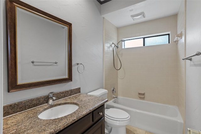 full bathroom featuring toilet, tiled shower / bath, and vanity