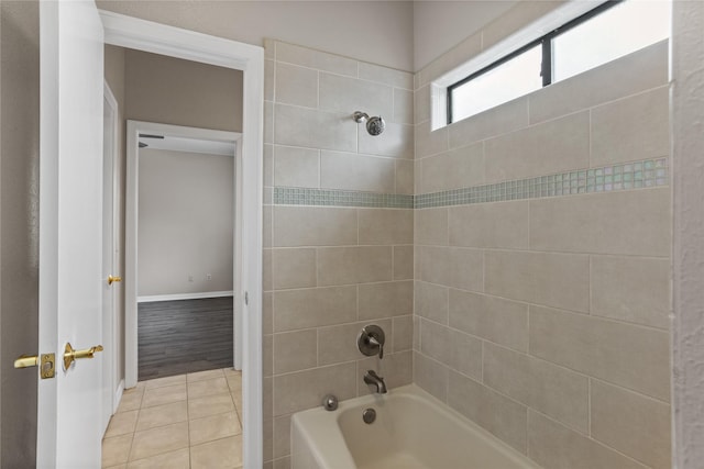 bathroom with tiled shower / bath and tile patterned flooring