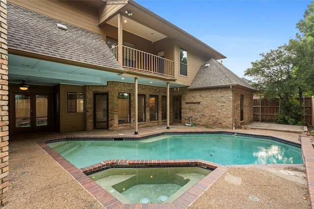 view of swimming pool with an in ground hot tub