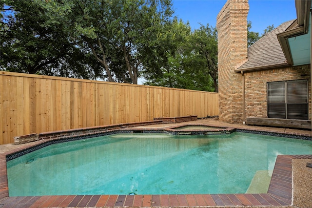 view of pool with an in ground hot tub