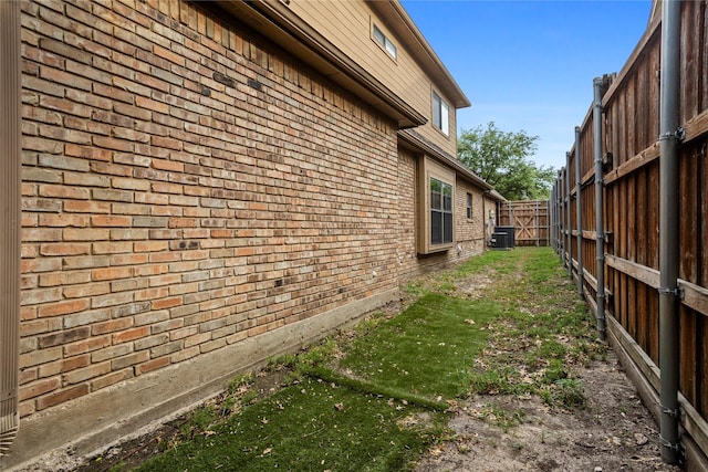 view of side of property with central air condition unit