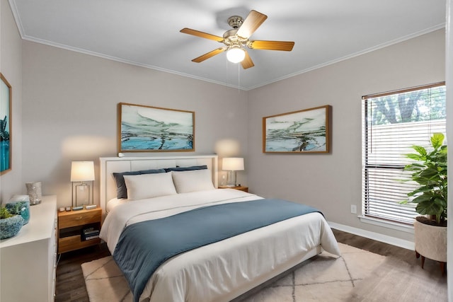 bedroom featuring ceiling fan, crown molding, and dark hardwood / wood-style floors