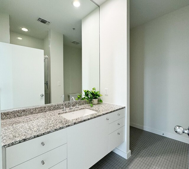 bathroom with vanity and tile floors