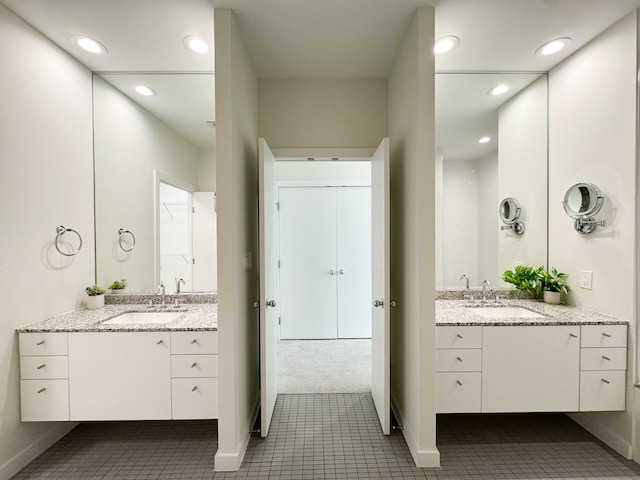 bathroom with tile flooring and double vanity