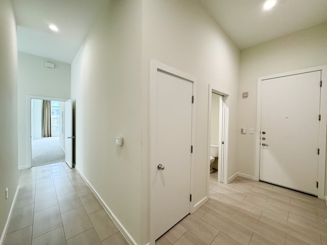 hall featuring light tile floors