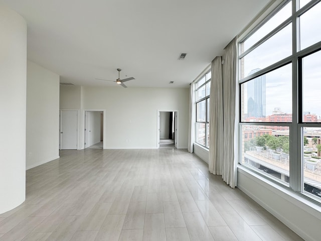 unfurnished living room featuring ceiling fan