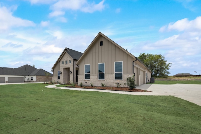 view of front of house with a front yard and a garage