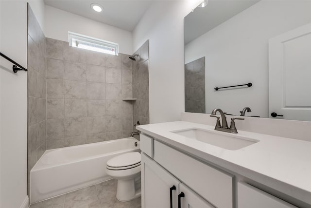 full bathroom featuring tile patterned floors, tiled shower / bath combo, toilet, and vanity