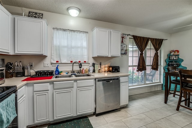 kitchen with white cabinets, dishwasher, light tile floors, sink, and a textured ceiling